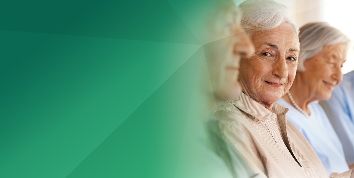 three elderly persons sitting next to each other and smiling