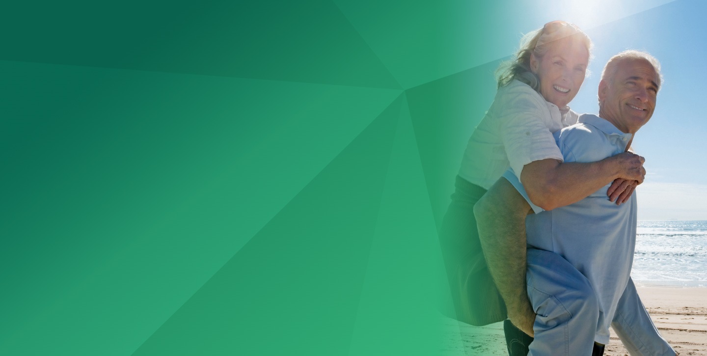 old couple, husband having his wife piggyback on the beach