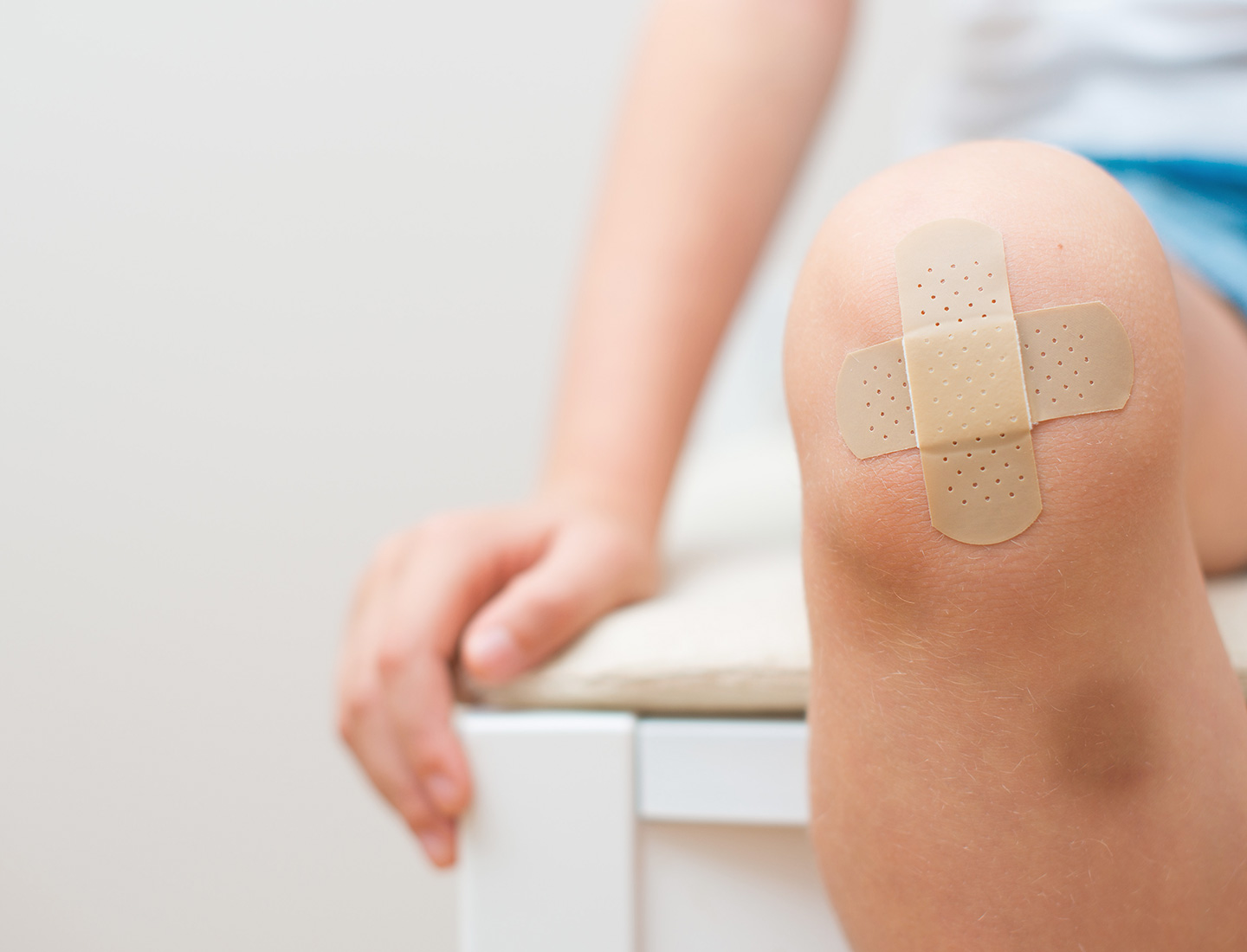 A woman using a HARTMANN product for the wound on her arm