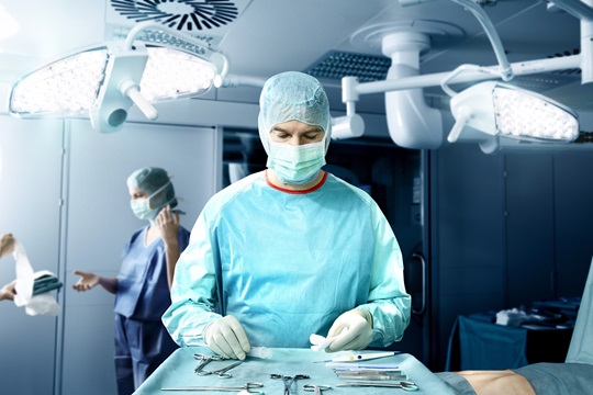 doctor wearing a surgical gown during a surgery