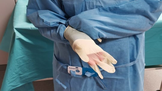 Image showing how to pull up the cuff and insert the fingers into the glove.